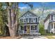 Charming two-story home with a welcoming porch and a bright yellow front door at 3 Maple St, Raleigh, NC 27610
