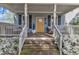 Inviting front porch with seating and white azaleas at 3 Maple St, Raleigh, NC 27610