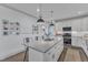 A kitchen with stainless steel appliances, white cabinetry, and a center island with bar stool seating at 3 Maple St, Raleigh, NC 27610