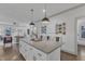 An open kitchen layout with bar stool seating at the island and a view to the living room at 3 Maple St, Raleigh, NC 27610