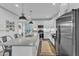 Spacious kitchen featuring a center island with seating and stainless steel refrigerator at 3 Maple St, Raleigh, NC 27610