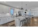 Open concept kitchen with a large island, stainless steel appliances, and white cabinets with dark hardware at 3 Maple St, Raleigh, NC 27610
