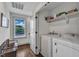 Efficient laundry room with modern washer and dryer, organized shelving, and natural light for convenient chores at 3 Maple St, Raleigh, NC 27610