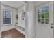 Inviting mudroom featuring shiplap accent wall, convenient bench with storage cubbies, and a bright, welcoming atmosphere at 3 Maple St, Raleigh, NC 27610