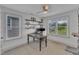 Bright home office featuring a stylish desk, ceiling fan, and ample natural light, creating a productive workspace at 3 Maple St, Raleigh, NC 27610