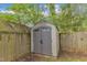 Backyard features a gray shed, a wooden fence, and lush greenery at 3 Maple St, Raleigh, NC 27610
