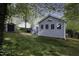 Spacious backyard featuring a well-maintained lawn, storage shed, and privacy fence at 300 Round About Rd, Holly Springs, NC 27540