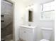 Bright bathroom features tiled shower, modern vanity, and natural light from window at 300 Round About Rd, Holly Springs, NC 27540