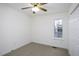 Neutral bedroom features a window for natural light, adding warmth to this carpeted living space at 300 Round About Rd, Holly Springs, NC 27540