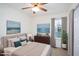 A serene bedroom boasts neutral tones, natural light from a window, and inviting, comfortable furnishings at 300 Round About Rd, Holly Springs, NC 27540