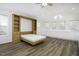 Bonus room boasts wood floors and a Murphy bed for versatile living, flooded with natural light at 300 Round About Rd, Holly Springs, NC 27540
