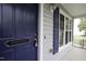 Close-up of the front door showcasing the blue color, stylish welcome sign, and charming details at 300 Round About Rd, Holly Springs, NC 27540