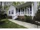 Charming home featuring a welcoming front porch with white railings and blooming flowers at 300 Round About Rd, Holly Springs, NC 27540
