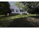 Landscaped front yard showcasing a well-maintained lawn and beautiful mature trees at 300 Round About Rd, Holly Springs, NC 27540