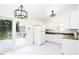 Bright kitchen with white cabinets, appliances, granite-look counters, and deck access at 300 Round About Rd, Holly Springs, NC 27540