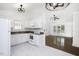 Bright kitchen with white cabinets and appliances open to the living room at 300 Round About Rd, Holly Springs, NC 27540