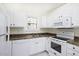 Kitchen features white cabinets, appliances and granite-look countertops at 300 Round About Rd, Holly Springs, NC 27540