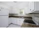 Bright kitchen with white cabinets, appliances and granite-look counters at 300 Round About Rd, Holly Springs, NC 27540