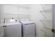 Functional laundry area with washer, dryer and ample shelving for storage at 300 Round About Rd, Holly Springs, NC 27540