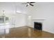 Bright living room features a fireplace, hardwood floors, and seamless flow into the kitchen at 300 Round About Rd, Holly Springs, NC 27540