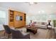 Living room features a Murphy bed, bright windows, wood flooring, and inviting seating, great for entertaining at 300 Round About Rd, Holly Springs, NC 27540