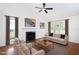 Staged living room with fireplace, hardwood floors, sofa, chairs, coffee table, and decor at 300 Round About Rd, Holly Springs, NC 27540