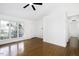 Bright living room features a ceiling fan and beautiful hardwood floors at 300 Round About Rd, Holly Springs, NC 27540