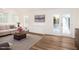 A sunlit living room with wood floors, built-in cabinets, and French doors for a warm, inviting atmosphere at 300 Round About Rd, Holly Springs, NC 27540