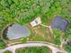 Aerial view showcasing a community playground, pond, and basketball court surrounded by lush greenery at 307 Parkmeadow Dr, Cary, NC 27519