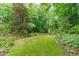 A well-manicured lawn backs up to a wooded area in the backyard, creating a private oasis at 307 Parkmeadow Dr, Cary, NC 27519