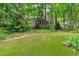 Spacious backyard with lush green lawn and mature trees provides a private oasis at 307 Parkmeadow Dr, Cary, NC 27519