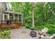 Inviting backyard with mature trees, a patio area, a fire pit and a screened-in porch at 307 Parkmeadow Dr, Cary, NC 27519