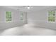 Spacious bedroom with neutral walls, large windows offering natural light, and cozy carpeting at 307 Parkmeadow Dr, Cary, NC 27519