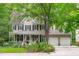 Charming two-story home with a welcoming front porch, mature trees, and a two-car garage at 307 Parkmeadow Dr, Cary, NC 27519