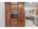 Kitchen view showcasing custom cabinets, granite counters, stainless microwave, with view to eating area at 307 Parkmeadow Dr, Cary, NC 27519