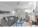 Bright living room featuring a comfortable sofa, area rug, and fireplace, creating an inviting and cozy atmosphere at 307 Parkmeadow Dr, Cary, NC 27519
