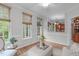 Bright sitting room featuring hardwood floors and multiple windows providing views to the exterior at 307 Parkmeadow Dr, Cary, NC 27519