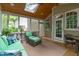 View of screened-in porch shows wood ceiling, skylight and views of wooded backyard at 307 Parkmeadow Dr, Cary, NC 27519
