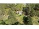 Aerial view of the property with a large yard, shed, and surrounded by mature trees at 310 Edward Ln, Louisburg, NC 27549