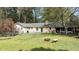Spacious backyard with a fire pit, fenced yard and a covered garage at 310 Edward Ln, Louisburg, NC 27549