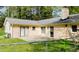 Home's backyard featuring fenced yard, patio and mature trees at 310 Edward Ln, Louisburg, NC 27549