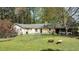 Spacious backyard featuring a well-maintained lawn, a fire pit, and a charming fence at 310 Edward Ln, Louisburg, NC 27549