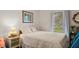 Comfortable bedroom featuring a soft quilt, a side table and plenty of natural light at 310 Edward Ln, Louisburg, NC 27549