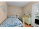 Bedroom showcasing a floral bedspread and natural light from the nearby window at 310 Edward Ln, Louisburg, NC 27549
