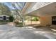 Spacious carport area with adjacent outbuilding and well manicured landscaping and trees at 310 Edward Ln, Louisburg, NC 27549