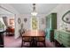 Formal dining room featuring a wooden table, six chairs, and vintage green china cabinet at 310 Edward Ln, Louisburg, NC 27549