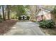 Wide driveway with a shed and a partial view of the side of the house with an American flag at 310 Edward Ln, Louisburg, NC 27549