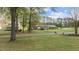 Spacious property featuring a well-manicured lawn and mature trees in a quiet neighborhood at 310 Edward Ln, Louisburg, NC 27549