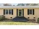 Charming front entrance with an elegant door, stairs, and attractive black shutters at 310 Edward Ln, Louisburg, NC 27549