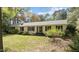 Inviting single-story home featuring a classic brick exterior and well-manicured lawn at 310 Edward Ln, Louisburg, NC 27549